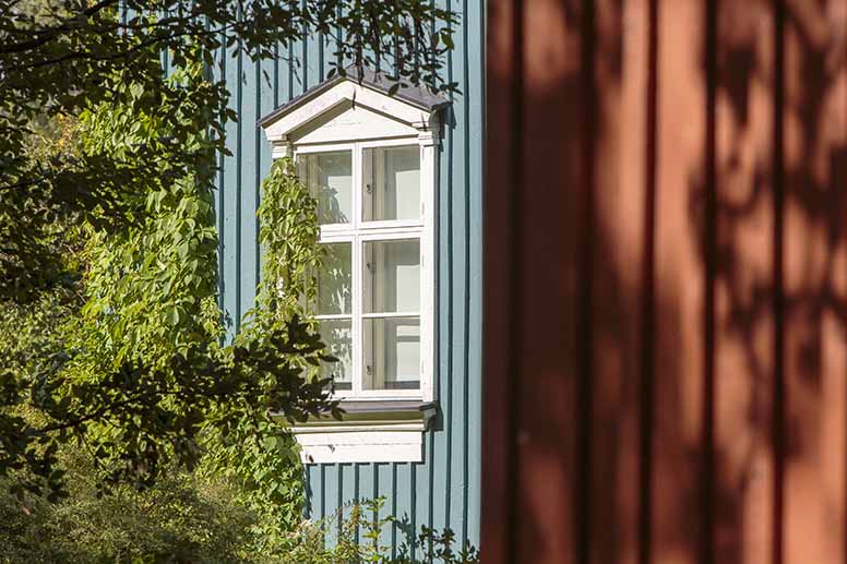 Sinisen puutalon koristeellinen ikkuna
