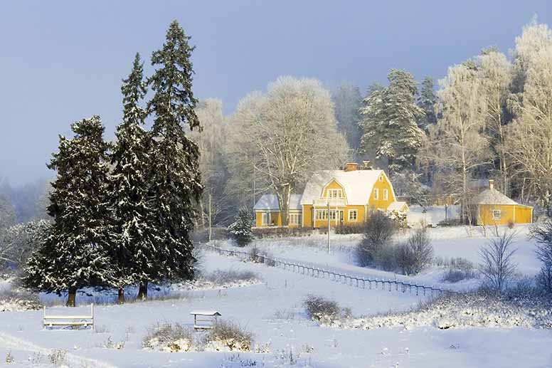Keltainen omakotitalo pakkasmaisemassa
