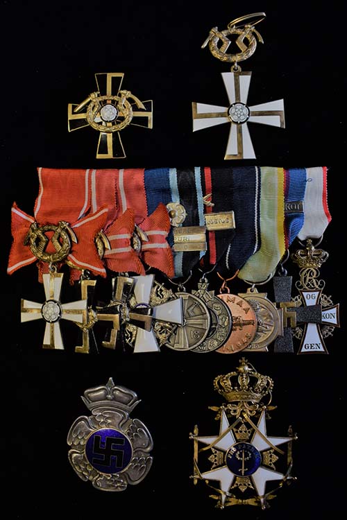 Erittäin harvinaiseen huutokauppakohteeseen kuuluu mm. Vapaudenristin 2. luokan Mannerheim-risti, Vapaudenristin 1. luokan risti 1941 miekkojen kera sekä kunniamerkkiripa, jossa on mm. Vapaussodan muistomitali ruusukkeella, soljilla Tampere, Viipuri ja Savo, Ilmavoimien muistoristi soljella Lentojoukot sekä Tanskan Dannebrogin ritarikunnan ritariristi. Kuva: Suomen Numismaattinen Yhdistys