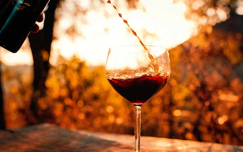Viinilasiin kaadetaan punaviiniä